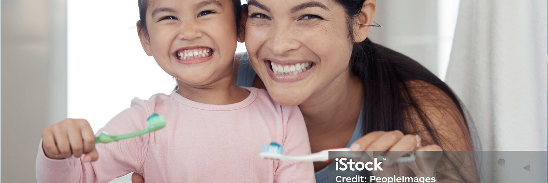 Mother and daughter brushing teeth for their dentist in Idaho Falls.