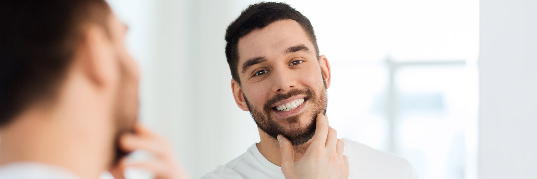 Man checking his CEREC dental crown received from his dentist in Idaho Falls, Dr. Michael Elison.