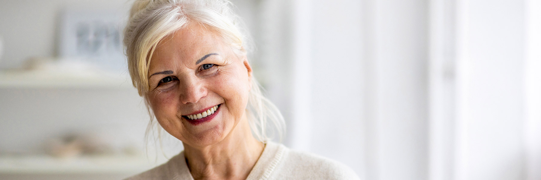 Woman smiling with a dental bridge from dentist in Idaho Falls, Dr. Michael Elison.