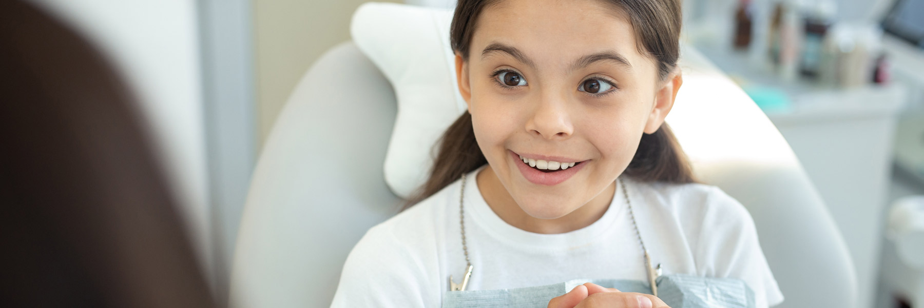 Happy young girl showing her teeth at the dentist in Idaho Falls.