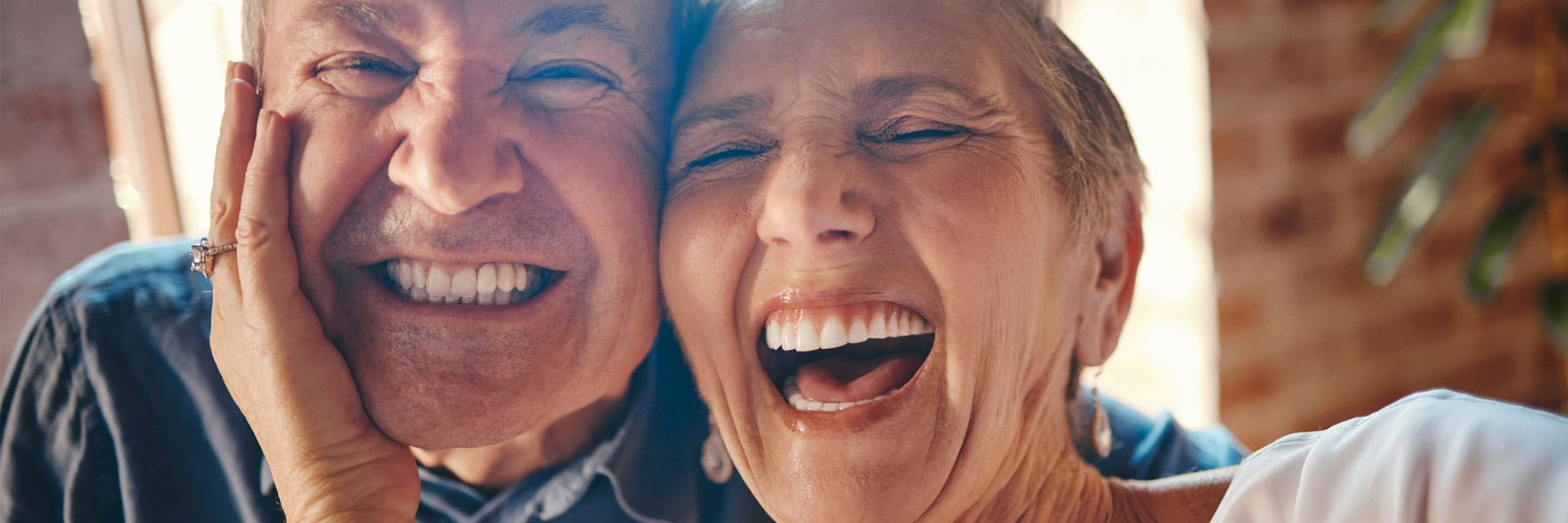 Elderly couple with big smiles, laughing and happy for their dentist in Idaho Falls, Dr. Michael Elison.