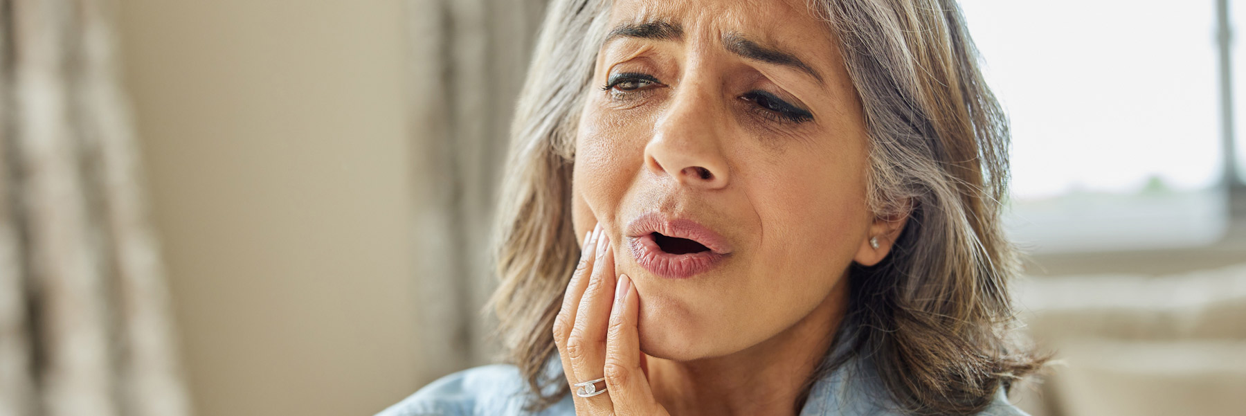 Woman in pain needing a root canal treatment from her family dentist in Idaho Falls, Dr. Michael Elison.