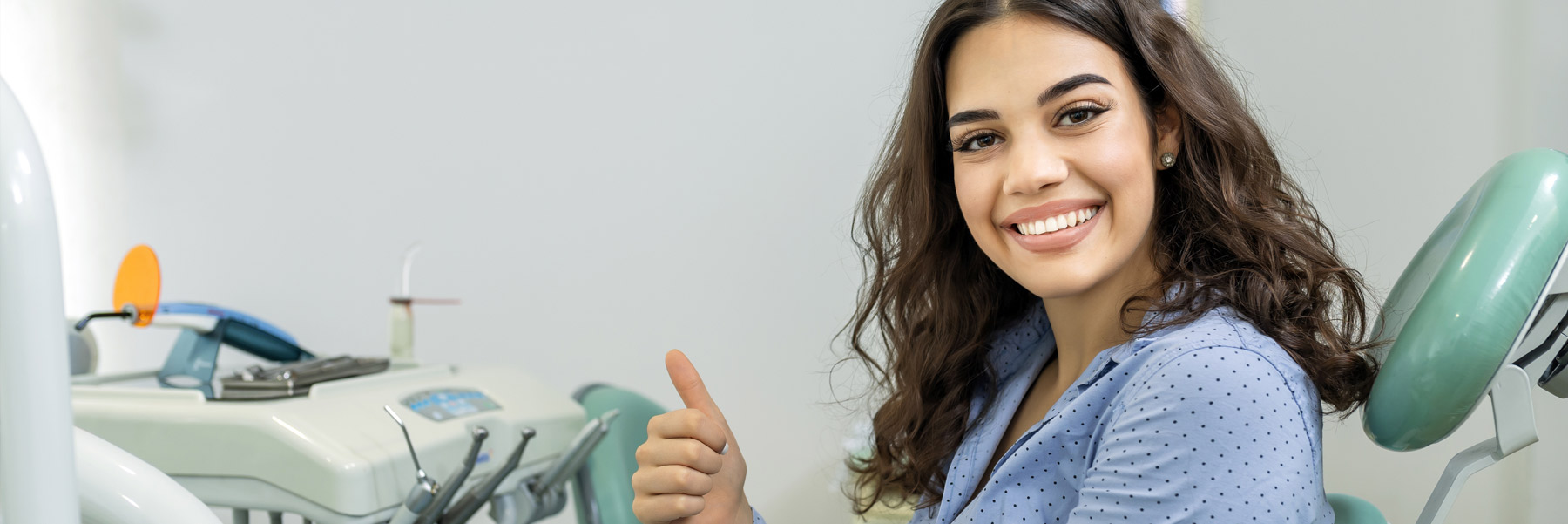 Young woman smiling and giving a thumb’s up for their dentist in Idaho Falls, Dr. Michael Elison.