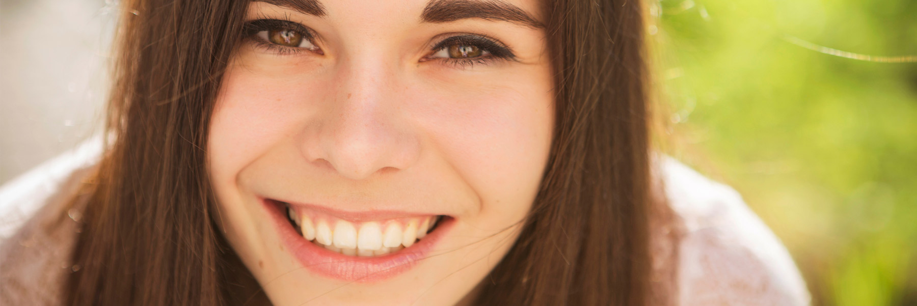 Teenage girl with braces, smiling after a visit with her family dentist in Idaho Falls, Dr. Michael Elison.