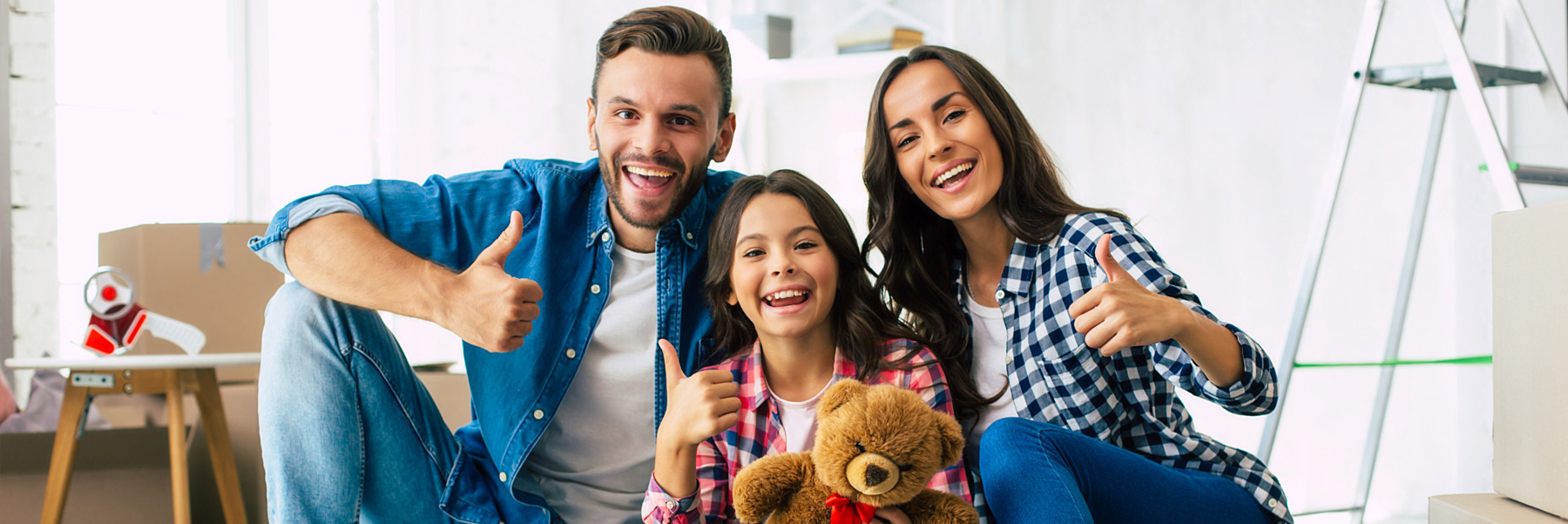 A family giving the thumbs up signal symbolizing their happy with their dentist in Idaho Falls, Dr. Michael Elison with his guarantee.