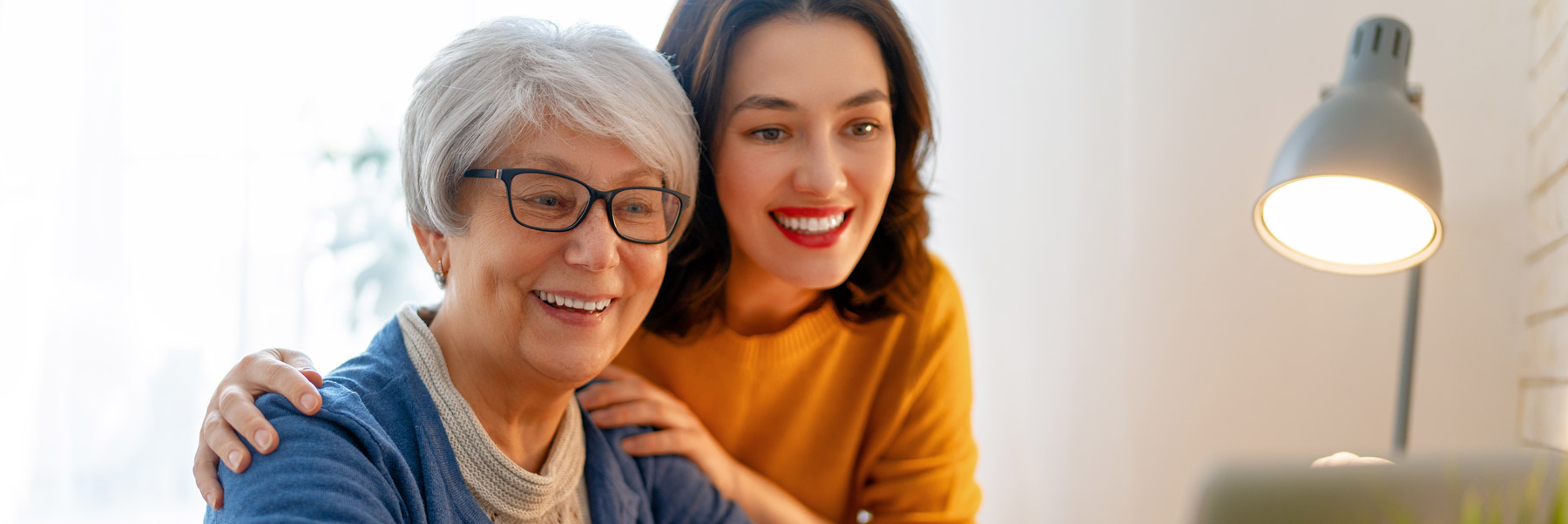 A mother and daughter looking online at important information from their dentist in Idaho Falls, Dr. Michael Elison.