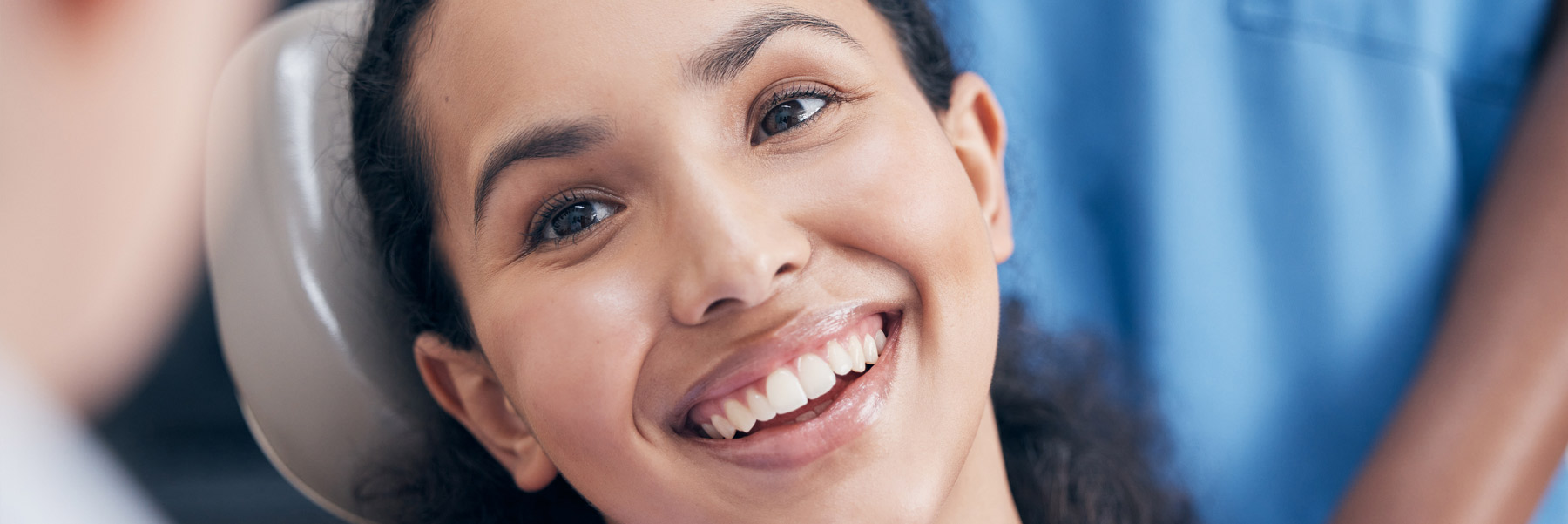 Smiling young woman in dental chair at her dentist in Idaho Falls, Elison Dental Center.